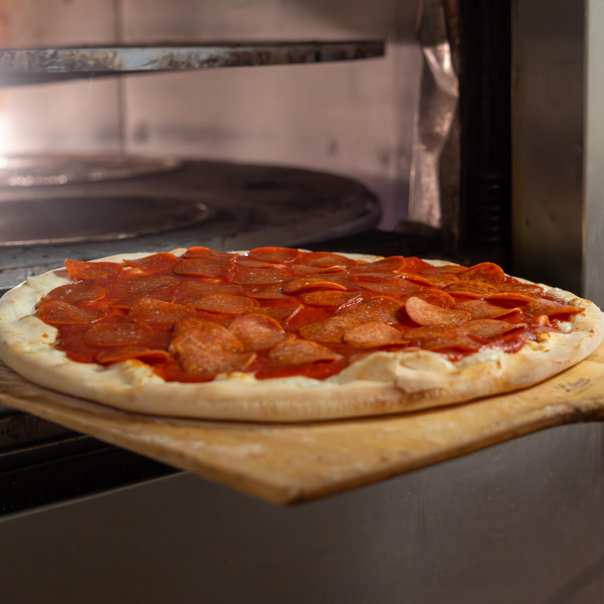 Pizza sliding into the brick oven at Moccia's